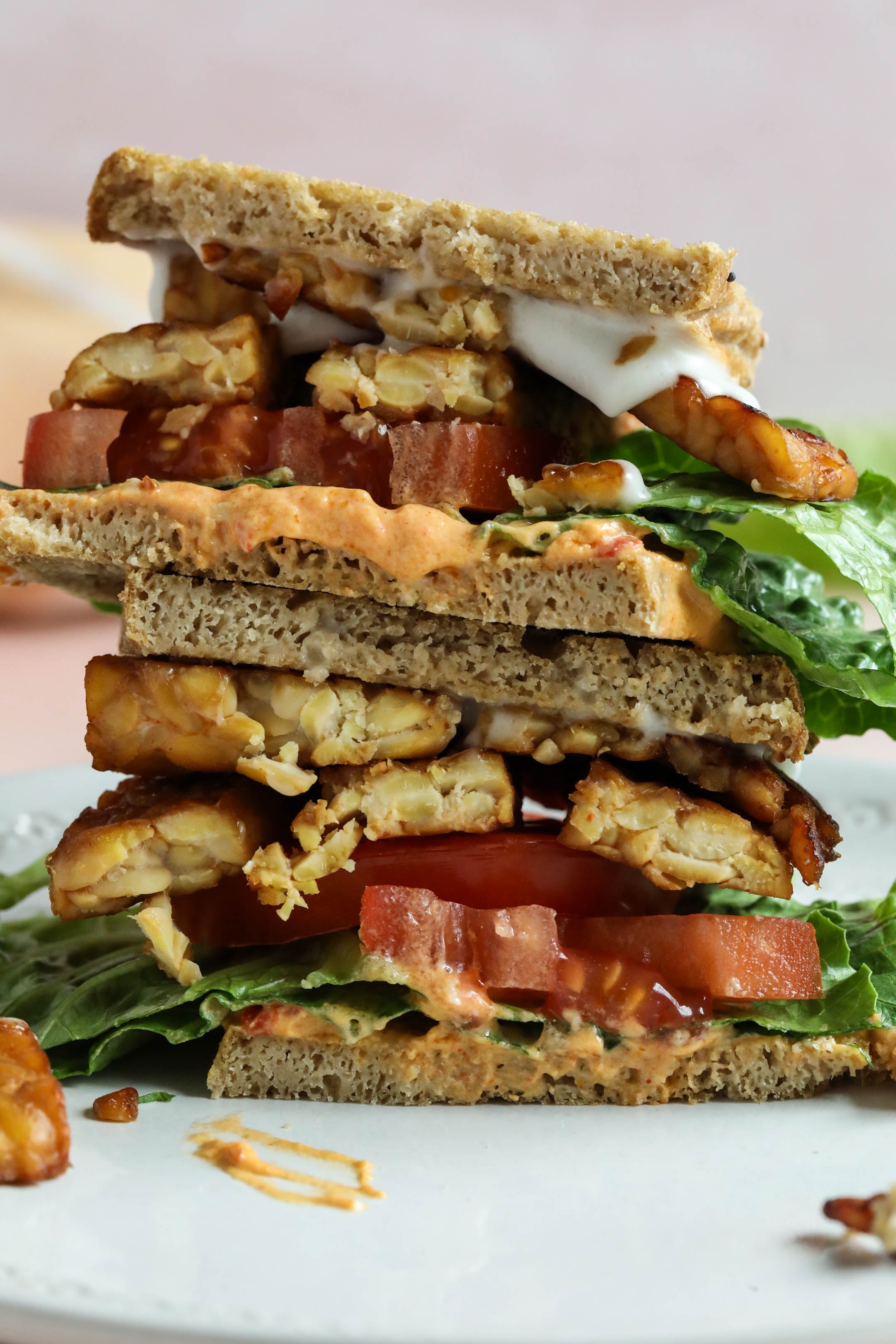 Two halves of a vegan BLT stacked on top of each other