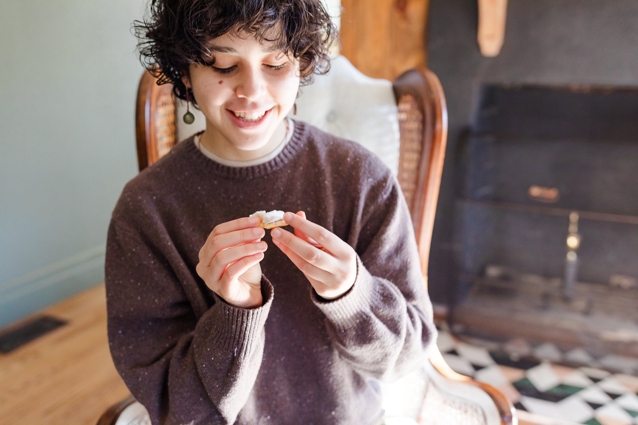 smiling person eating good vegan cheese