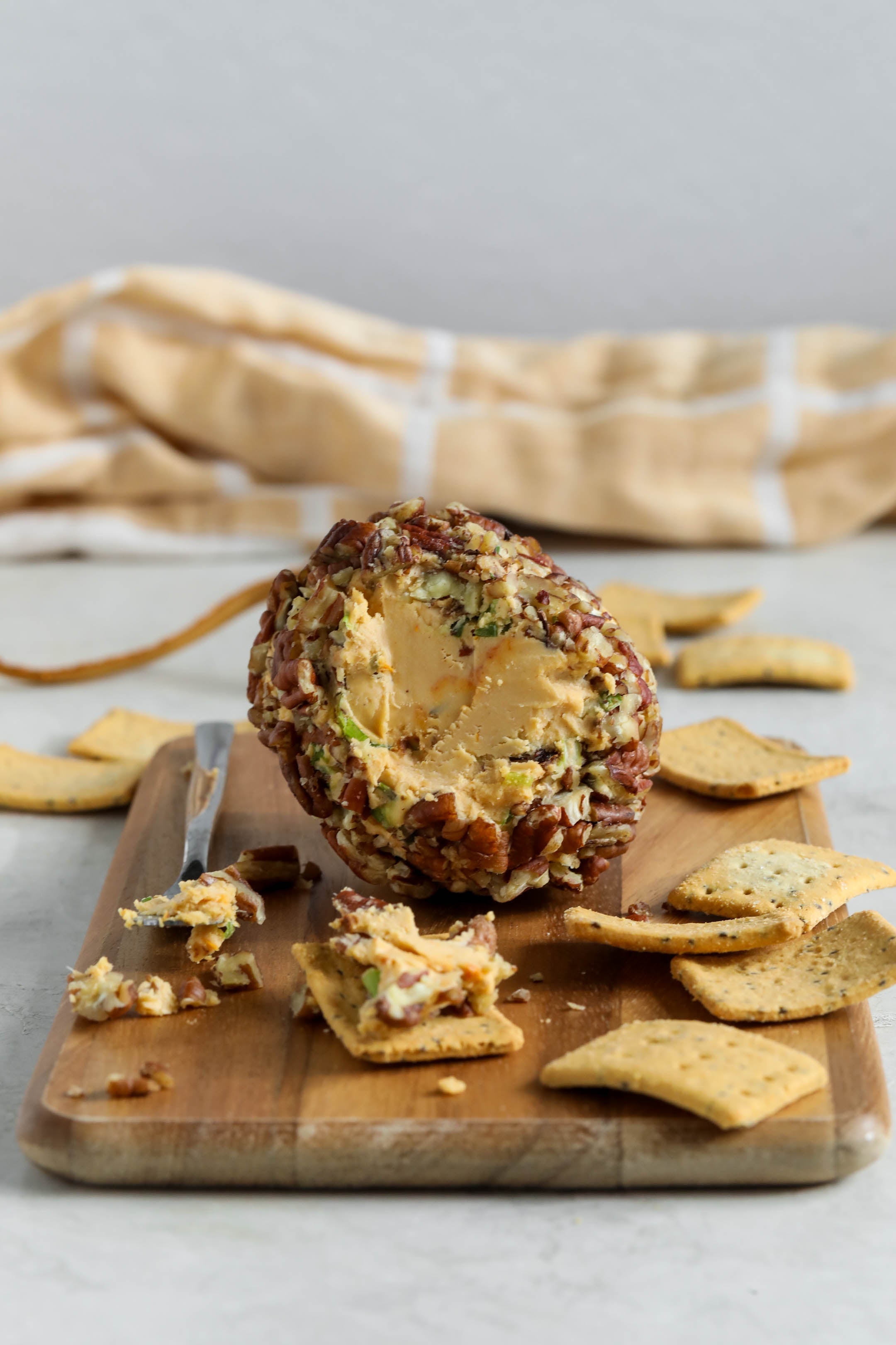 Vegan Cheeseball on board with crackers