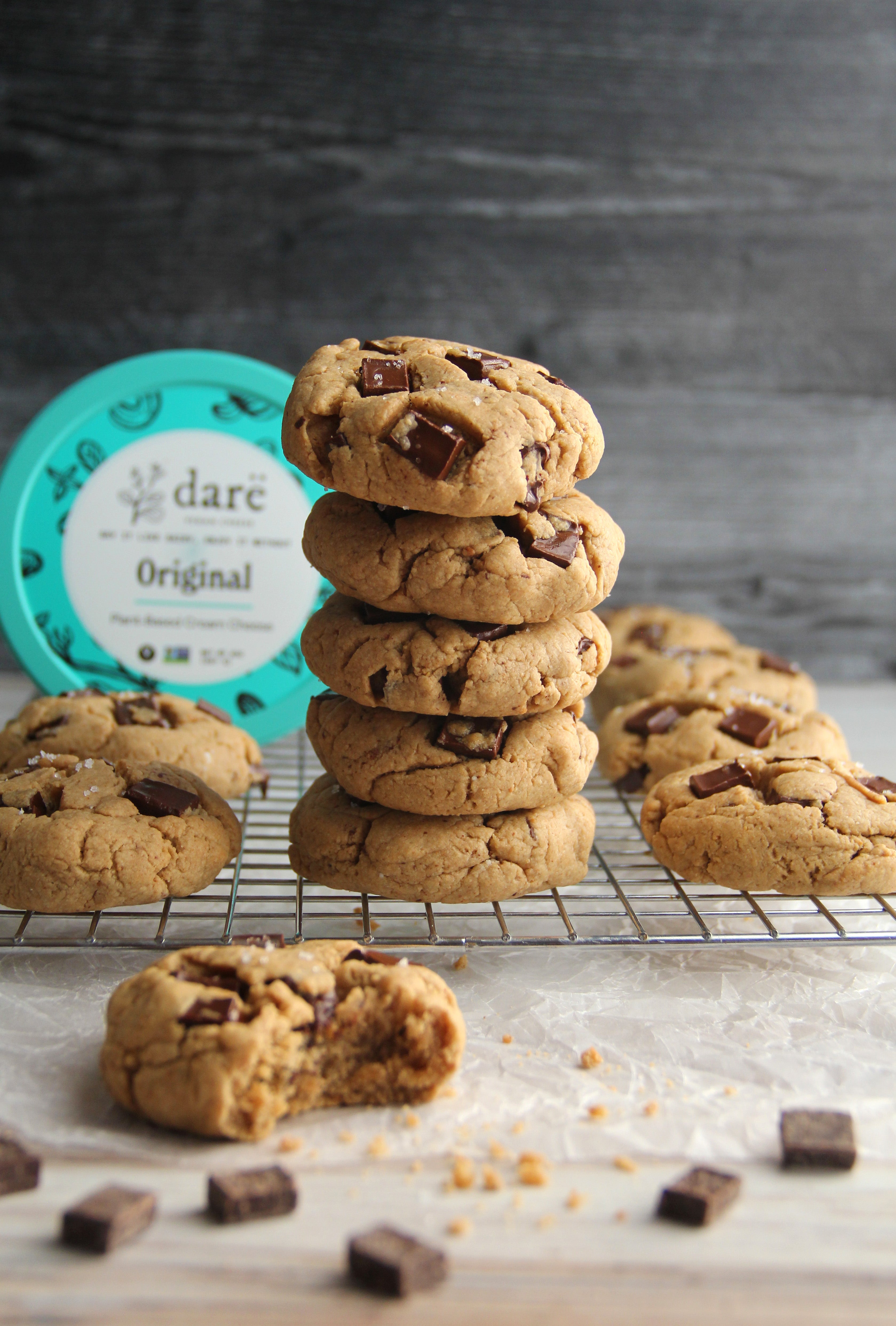 Cookies stacked with original cream cheese packaging in background