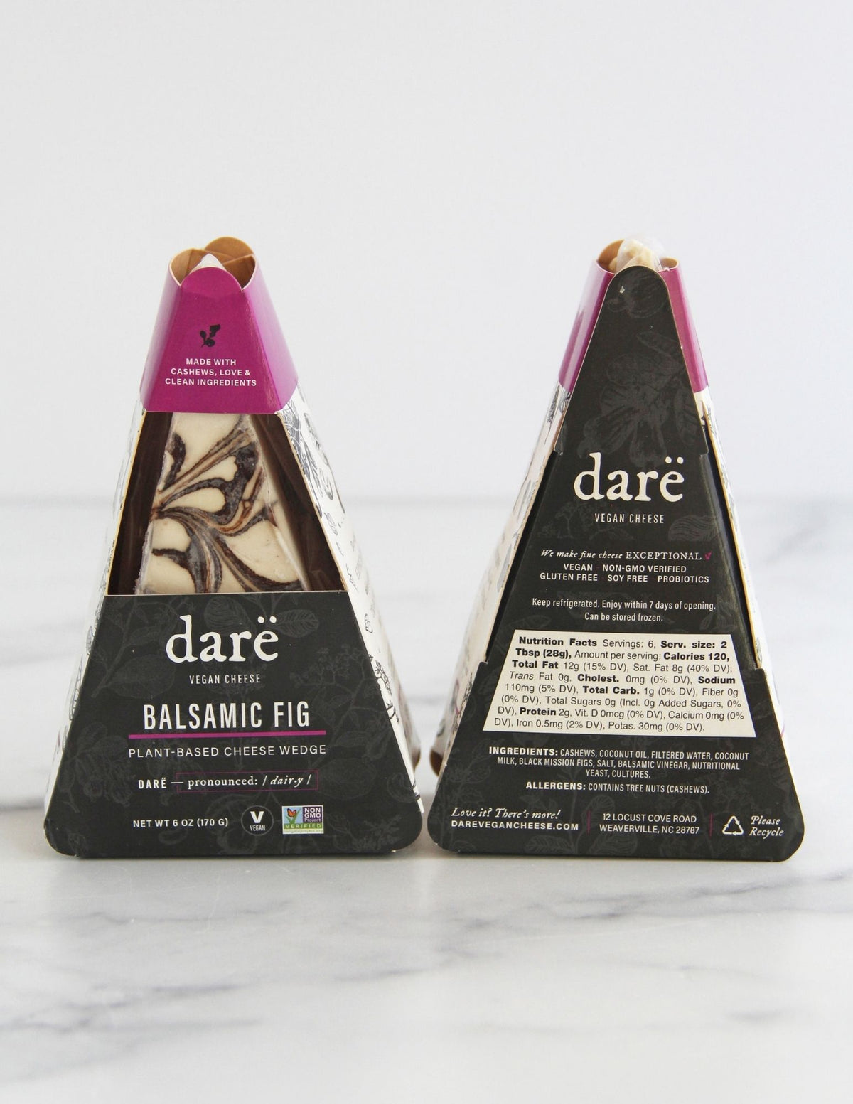 Darë Vegan Cheese Balsamic Fig plant-based cheese in its charcoal and purple packaging, the front and back showing on a light marble surface.