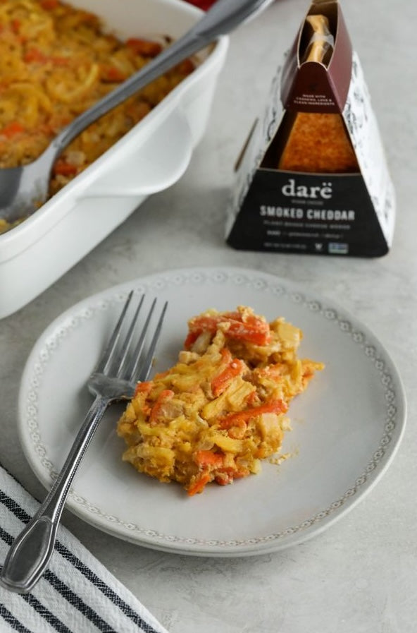 Plate of food with a fork and Dare Smoked Cheddar packaging on a gray surface