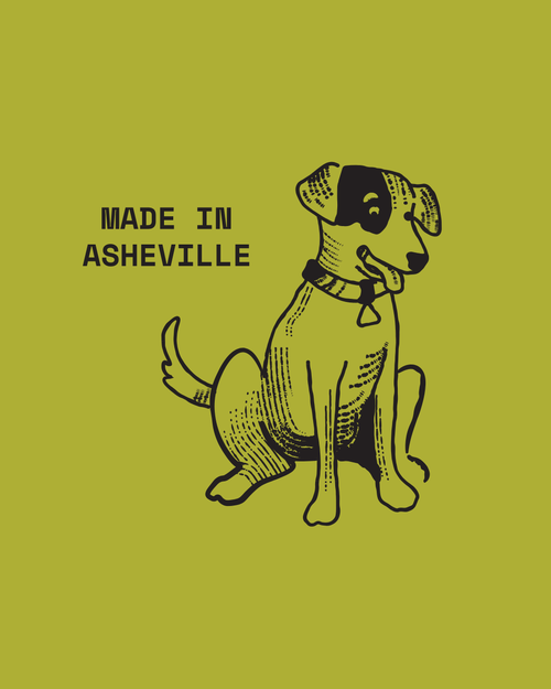 Load image 1 in gallery view. A graphic print featuring a black line art illustration of a dog on a solid olive green background, with the text 'MADE IN ASHEVILLE' printed to the left of the dog.