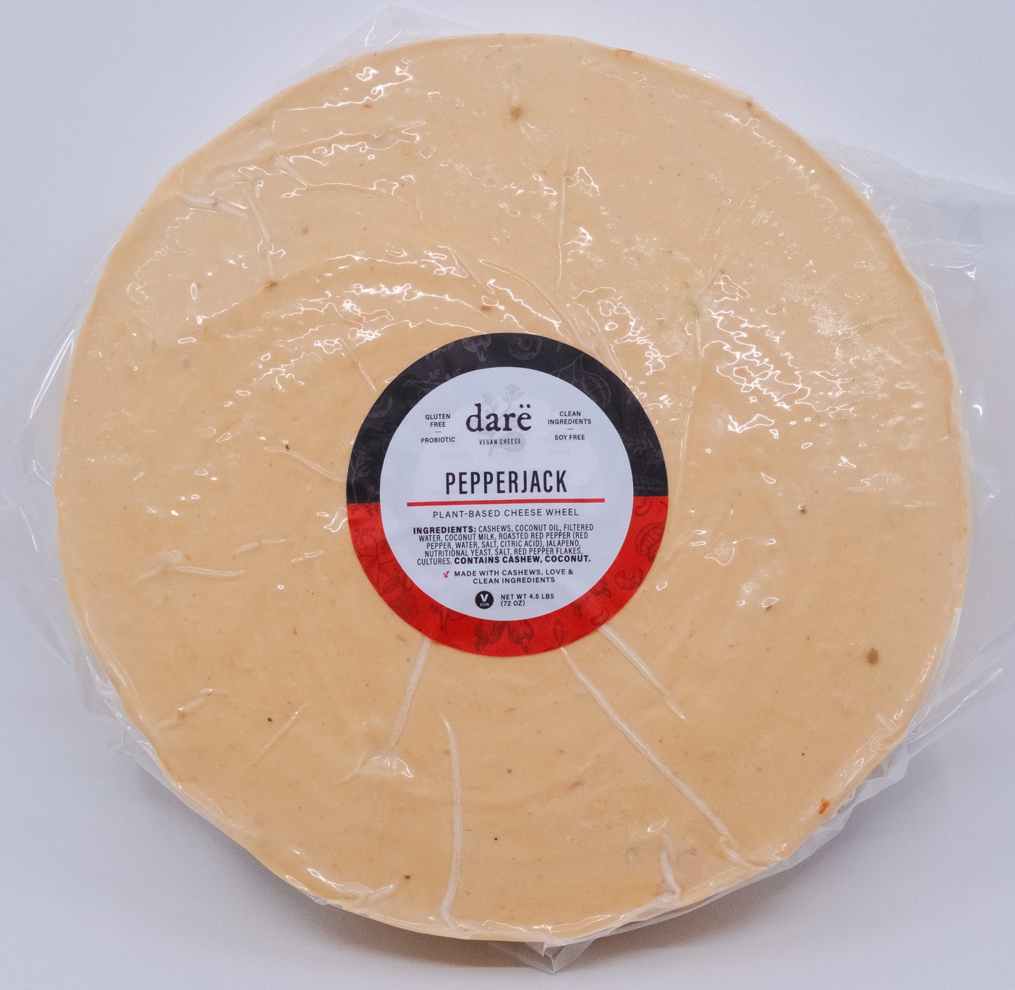 Pepperjack cheese wheel wrapped in plastic with a Dare label on a white background