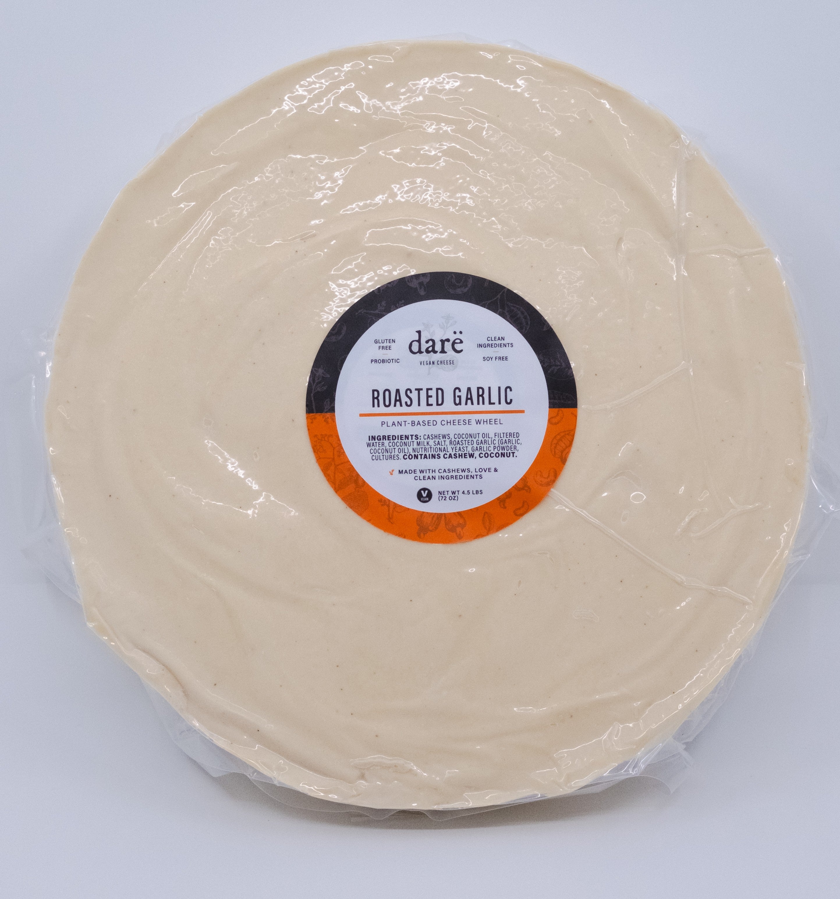 Round package of roasted garlic with a label on a light gray background
