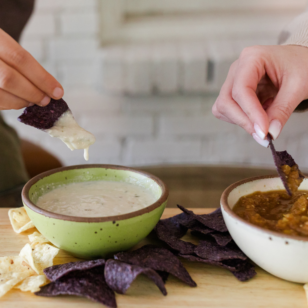 Darë Vegan Cheese brand Queso Blanco cheese dip on a tortilla chip