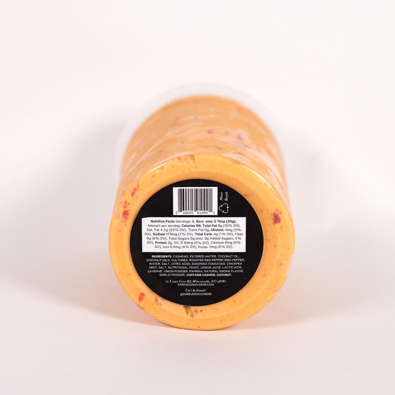 Block of cheese with a label on a white background