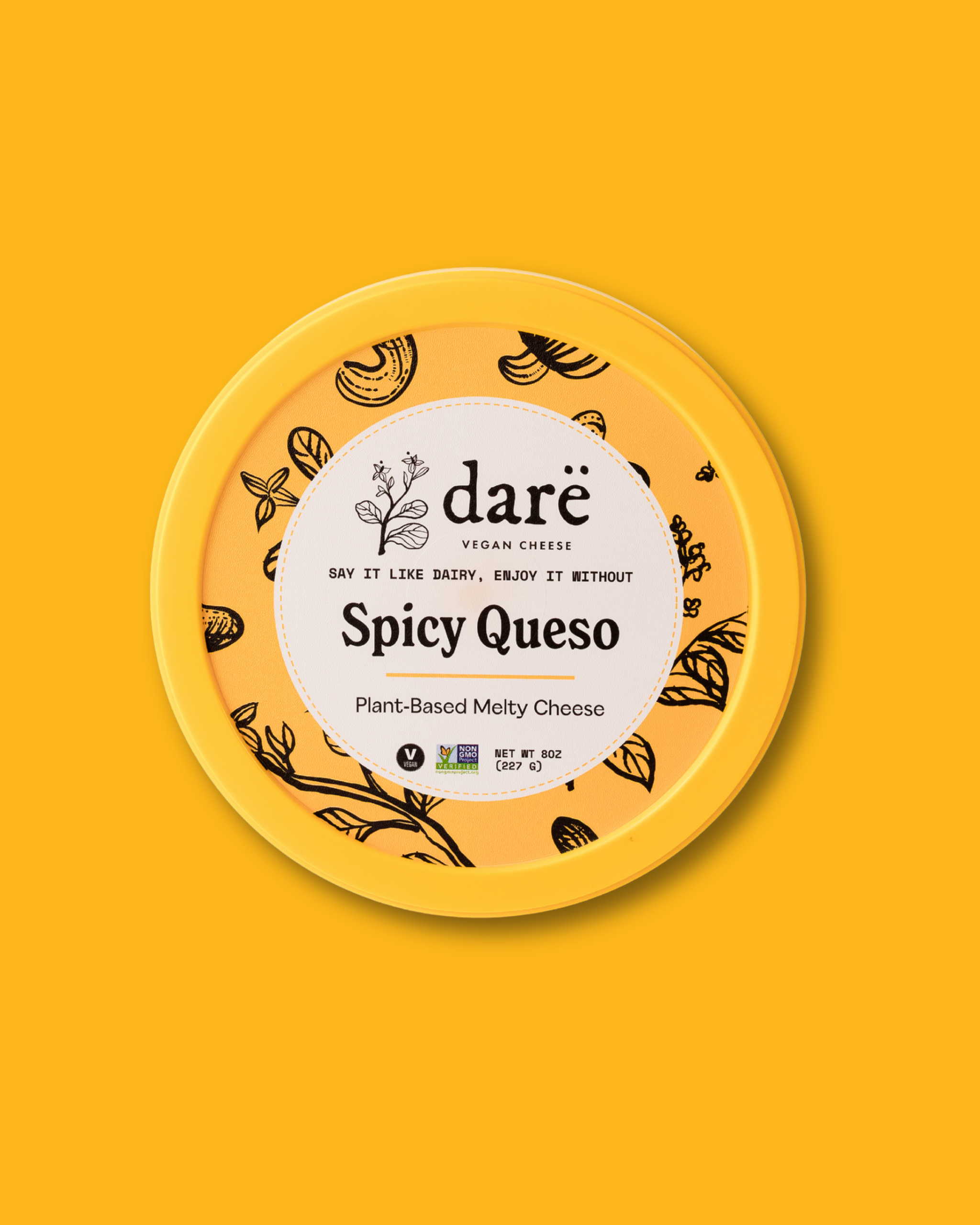 Dare Spicy Queso plant-based cheese container on a yellow background