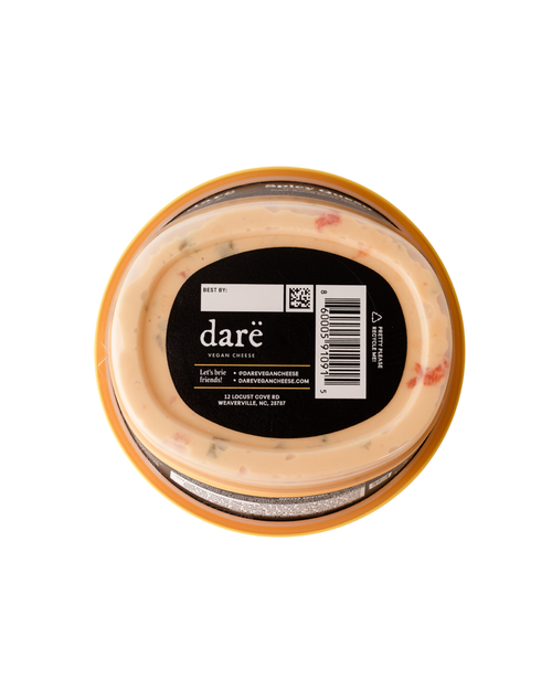 Load image 1 in gallery view. Container of Dare vegan cheese with a black label on a white background