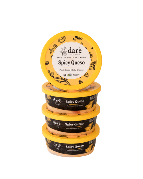 Load image 1 in gallery view. Stack of Dare Spicy Queso containers on a white background