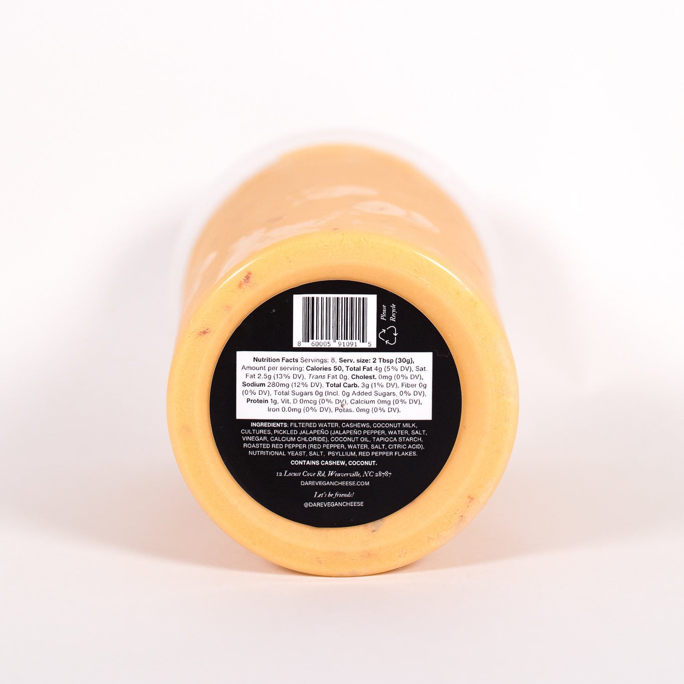 Round cheese wheel with a black label on a white background