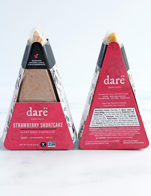 Load image 1 in gallery view. Two packaged dare vegan cheese plant-based cheesecake triangles on a white background, showing the front and back of the packaging for the Strawberry Shortcake flavor.