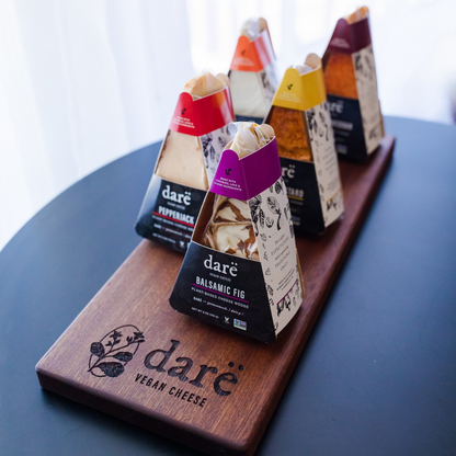 Darë Vegan Cheese brand dairy free cheese wedges on a wooden cheese board