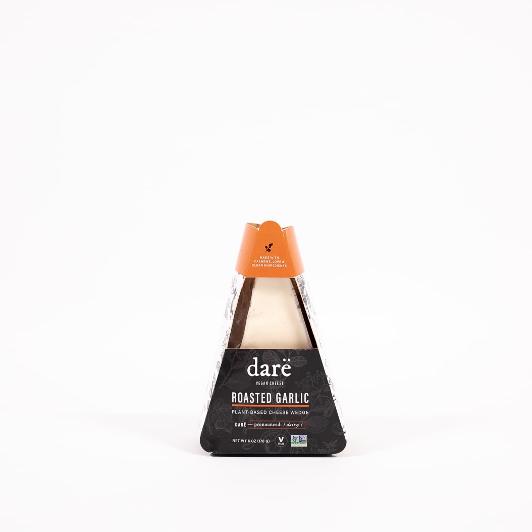 non dairy vegan roasted garlic cheese wedge product photo, vegan cheese in black and orange paper container