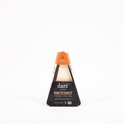Load image 1 in gallery view. non dairy vegan roasted garlic cheese wedge product photo, vegan cheese in black and orange paper container