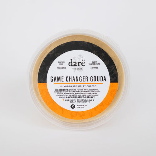 Load image 1 in gallery view. dare vegan cheese container on white background. label leads game changer gouda, orange and black container.