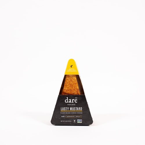 Load image 1 in gallery view. Lusty Mustard Plant Based Dragon Cheese Wedge product photo. black and yellow triangular container against white background